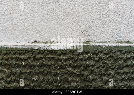 Aged dark green termal isolation wall texture grain rough surface compared to new white clean high quality construction in Sofia, Bulgaria, Eastern Stock Photo
