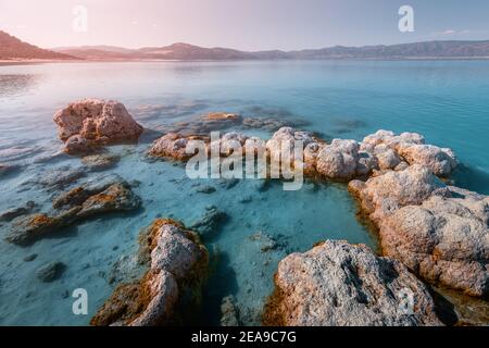 Beautiful and picturesque panoramic view of the lake or sea. Rocky formations and salty minerals in the foreground Stock Photo