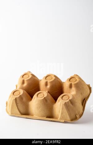 Top view of empty brown carton for six eggs, for recycling, white background, vertical, with copy space Stock Photo