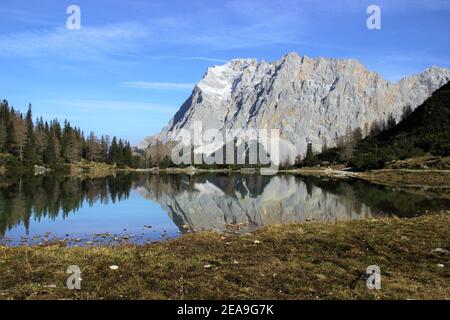 Austria, Tyrol, Ehrwald, Seebensee, Zugspitze, mirroring, water surface, Zugspitz massif, lake, mountain lake, mountains, alps, Wetterstein Mountains, mountain landscape, mountain landscape, idyll, mountain massif, mountain massif, sky, rock, mountain lake, water, tourism, late autumn, nature, Stock Photo