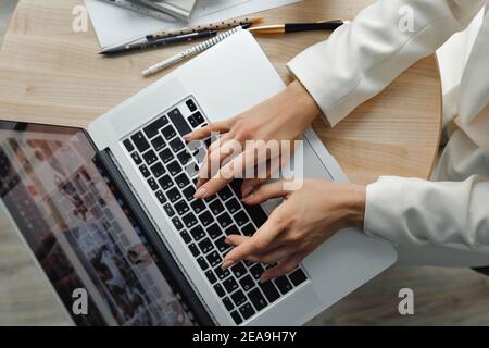 Woman working at laptop computer hands close up. Hand on keyboard close up Closeup of a female hands busy typing on a laptop. Working at home. Quarant Stock Photo