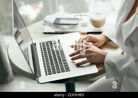 Closeup of a female hands busy typing on a laptop. Woman working at laptop computer hands close up. Working at home. Quarantine and Social distancing Stock Photo