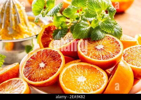 Blood sicilian oranges sliced with fresh melissa - close up Stock Photo