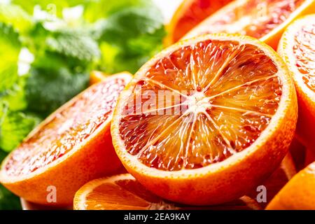 Blood sicilian oranges sliced with fresh melissa - close up Stock Photo