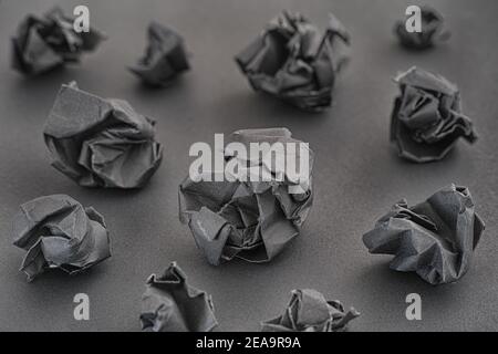 Crumpled black paper balls on a black background. Idea concept. Low key. Close up. Stock Photo