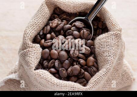 Coffee beans in a rustic jute bag Stock Photo