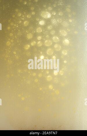 Beer. Light Beer with Bubbles and Foam Background Stock Photo