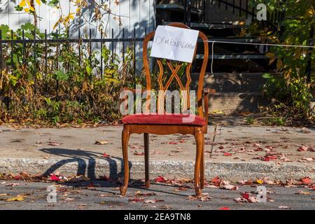 October 23, 2020- Montreal, Qc, Canada: Moving Day Sign on a chair  to reserve parking space on a narrow street during autumn Stock Photo