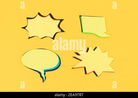 Paper speech bubbles on yellow background. Comic. Stock Photo