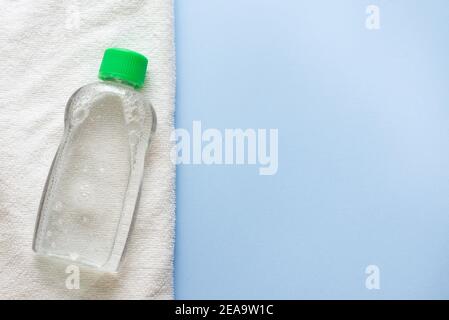 Daily cleansing cosmetics - face wash cleansing gel or smoothing toner and cotton cleansing pads isolated on blue background.copy space. place for tex Stock Photo