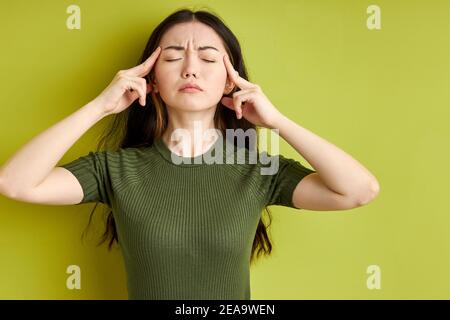 young brunette woman thinking with eyes closed, concentrated on thoughts. The concept of perception and reflection Stock Photo
