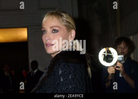 U.S. actress Sharon Stone poses surrounded by LVMH CEO Bernard Arnault (L)  and French Minister of Culture Renaud Donnedieu de Vabres upon arrival to  the cocktail reception for the inauguration of the