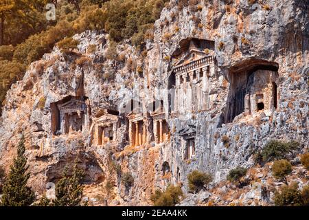 Famous historical and cultural monument - tombs of kings of ancient town Kaunos in modern city of Dalyan, Turkey. Architecture carved in rocks and cli Stock Photo