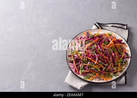 Red cabbage coleslaw salad with cumin and mustard sauce on gray background, top view, horizontal, free space Stock Photo