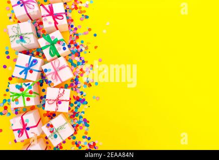 colorful gift boxes on a yellow background top view. Stock Photo