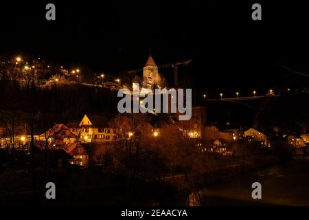 Landscape night view of the old town of Fribourg in Switzerland, with the 'Gotteron' bridge in the background Stock Photo