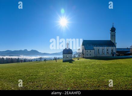 Germany, Bavaria, Upper Bavaria, Oberland, Irschenberg, district Wilparting with chapel St. Vitus and pilgrimage church St. Marinus and Anian against Wendelstein massif Stock Photo