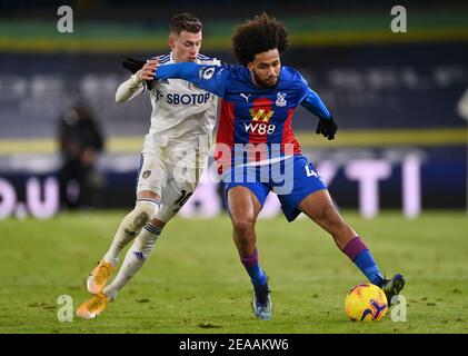 Leeds United's Ezgjan Alioski and Crystal Palace's Jairo Riedewald (right) battle for the ball during the Premier League match at Elland Road, Leeds. Picture date: Monday February 8, 2021. Stock Photo