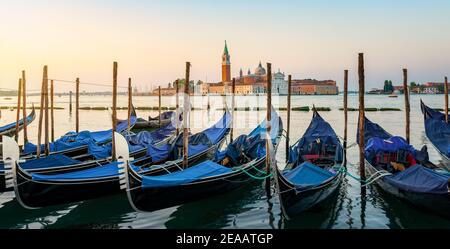 Moored Gondolas at venetian sunrise in front of San Giorgio Maggiore Stock Photo