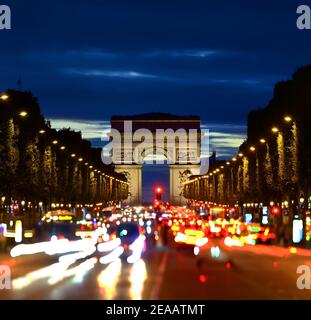 Illuminated Champs Elysee and view of Arc de Triomphe in parisian evening, France Stock Photo