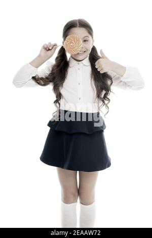 Healthy nutrition diet. Sweets reward for study. Rewarding herself with sweets. Food addictions. Girl kid eat sweet lollipop. Girl pupil school uniform like sweets lollipop candy white background. Stock Photo