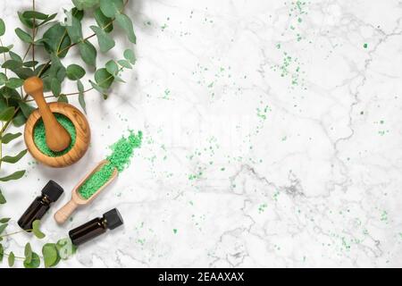 Natural aromatherapy with eucalyptus essential oil bottles and aromatic bath salts on marble background. Organic skin care products. Spa, wellness and Stock Photo