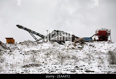 Old quarrying equipment in the snow Stock Photo