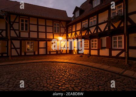 Germany, Saxony-Anhalt, Wernigerode, historical street lighting in an alley with half-timbered houses Stock Photo