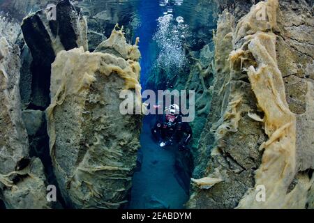 Nesgja, crystal clear freshwater fissure in Nesgja and divers, small tectonic continental fissure between America and Eurasia, Akureyri, northern Iceland Stock Photo