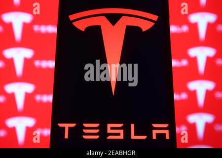 Ukraine. 08th Feb, 2021. In this photo illustration a Tesla logo is seen displayed on a mobile phone and a pc screen. Credit: SOPA Images Limited/Alamy Live News Stock Photo