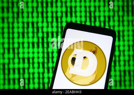Ukraine. 08th Feb, 2021. In this photo illustration a Dogecoin sign of a digital cryptocurrency is seen on a mobile phone and a pc screen. Credit: SOPA Images Limited/Alamy Live News Stock Photo