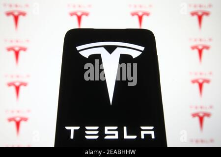 Ukraine. 08th Feb, 2021. In this photo illustration a Tesla logo is seen displayed on a mobile phone and a pc screen. Credit: SOPA Images Limited/Alamy Live News Stock Photo