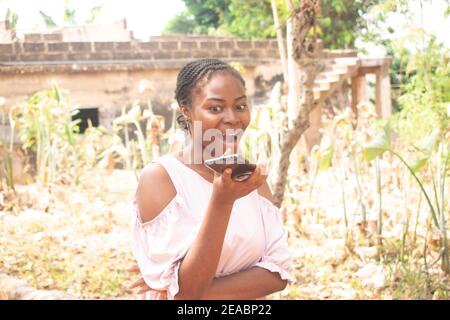 a young lady holding her phone Stock Photo