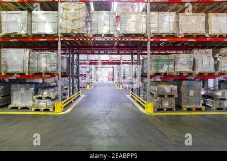 Finished goods warehouse, metal profile packed in bundles. Stock Photo