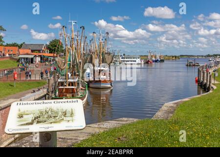 Information sign, historic Greetsiel, shrimp cutter in the port of Greetsiel, East Frisia, Lower Saxony, Stock Photo