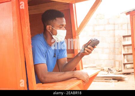 a young african businessman using a pos machine Stock Photo