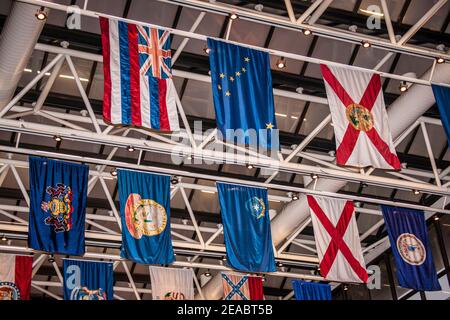 State flags hang above the lobby of Government Center Metrorail Station in downtown Miami, Florida. Stock Photo