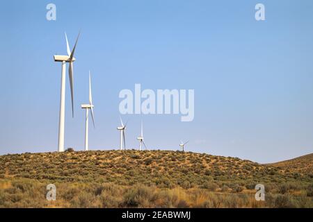 Wind Turbines on a Ridge. Wind turbines in a line on agricultural land in Washington State. Stock Photo