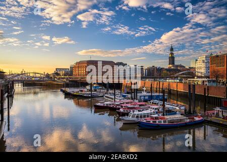 Sunset in the Binnenhafen (inland harbour) in Hamburg, Germany with the famous St Michael church in the background Stock Photo