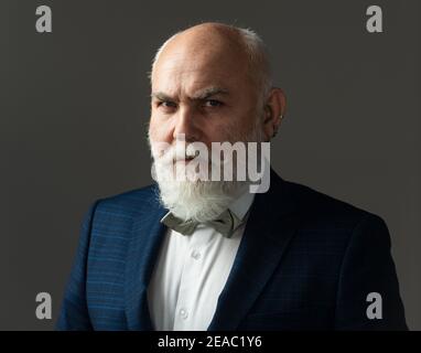 Serious Senior Man. Bearded middle-aged man with a serious expression in a closeup head and shoulders portrait.