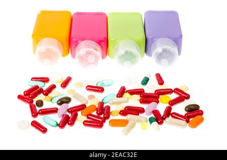 Multi-colored plastic bottles, containers with pills and capsules isolated on white background. Studio Photo Stock Photo