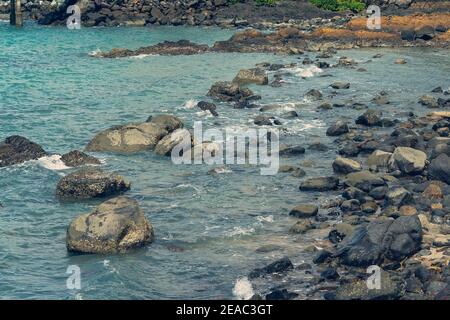 Water over rocks as the tide comes in on a coastal shoreline Stock Photo