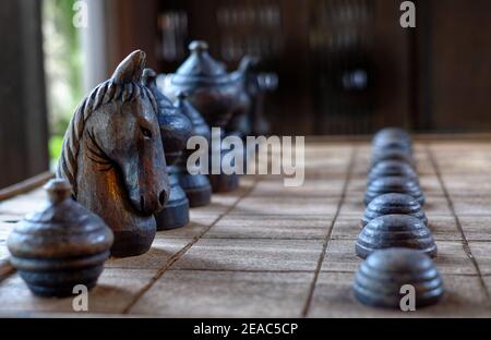 A closeup picture of knight piece of a wooden chess board set in its starting position. Stock Photo