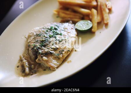 Halibut fillet steak with chips Stock Photo