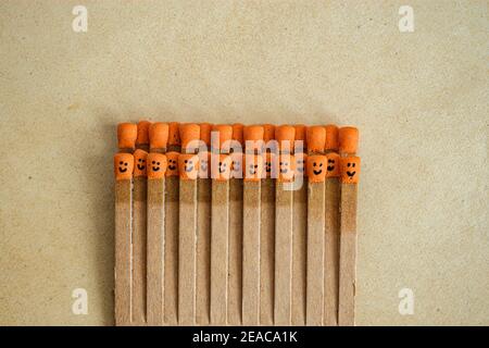 matchsticks with faces painted on the heads on old paper Stock Photo