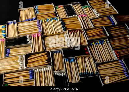 multicolored match sticks in boxes on a black background Stock Photo