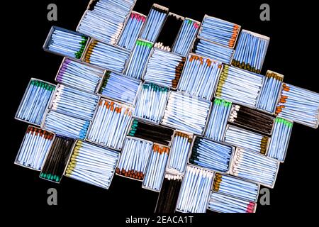 multicolored match sticks in boxes on a black background Stock Photo