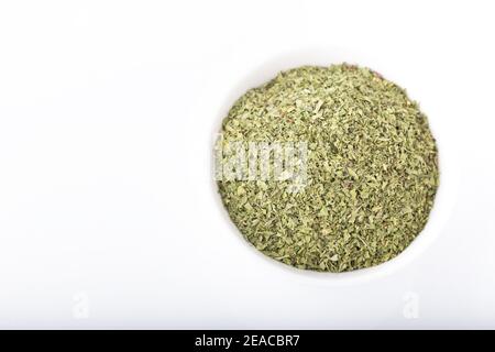 Dried peppermint in white bowl isolated on white background. Stock Photo