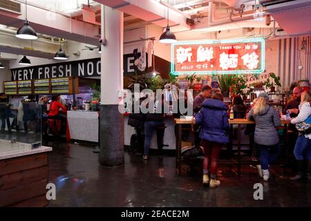 Very Fresh Noodles, 409 W 15th St, New York, NY. People at a Chinese hand-pulled noodle shop/food stall inside the Chelsea Market. Stock Photo