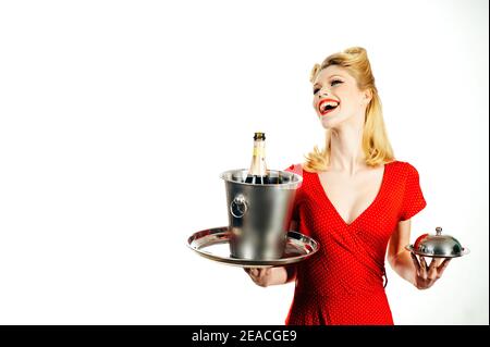 Woman waiter with champagne and service tray. Restaurant serving presentation. Stock Photo
